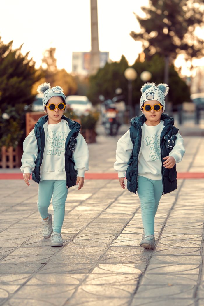 stats-img Two fashion-forward kids in matching outfits enjoy a stylish stroll outdoors. Perfect for fall fashion inspiration.